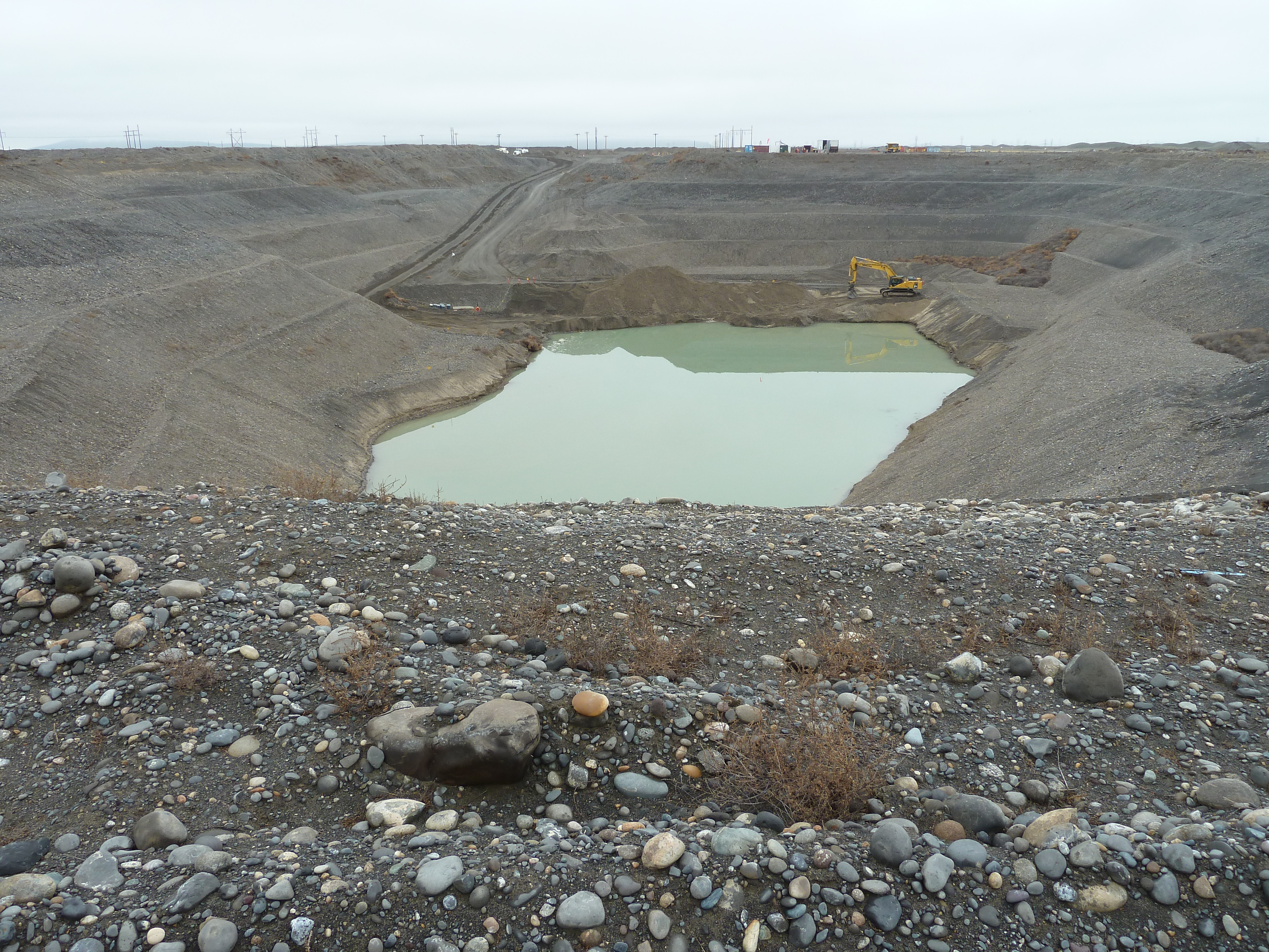 photo taken from the top of a large pit with liquids at the bottom