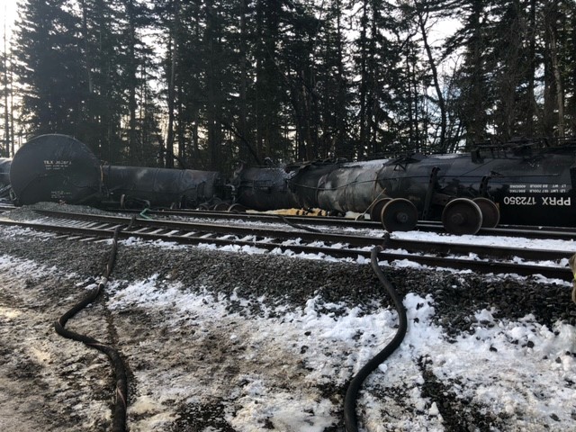 A derailed train in the snow.