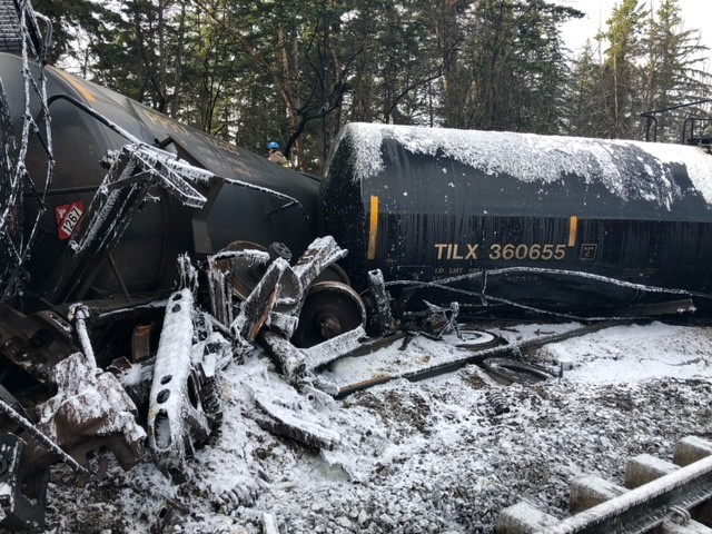 A derailed train in the snow.