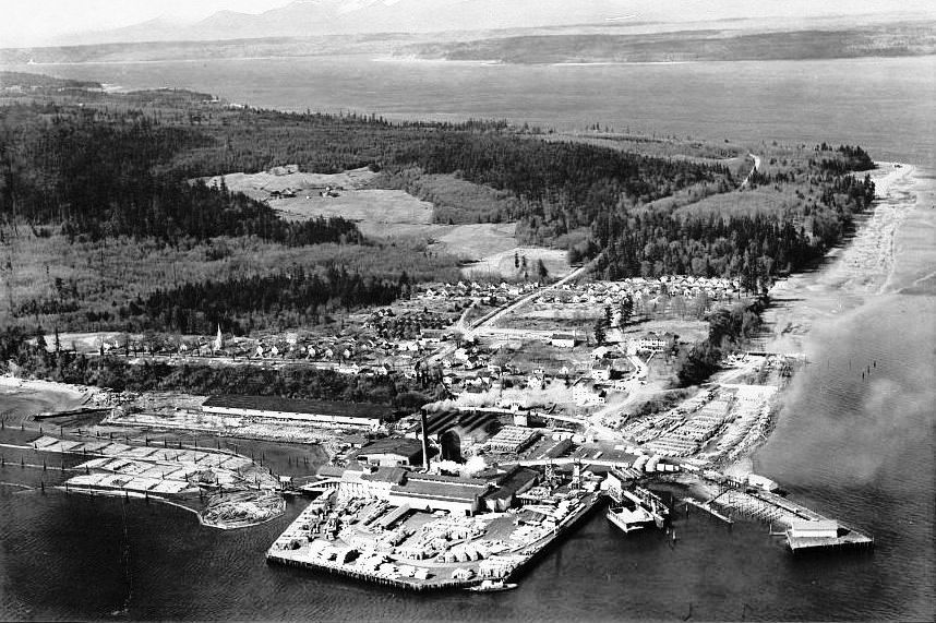 Old aerial photo of the mill, with structures covering the water.