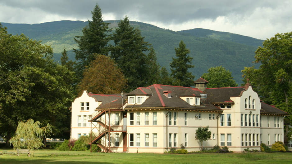 The northern State Hospital with trees and mountains in background