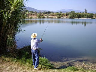 person with fishing pole in water