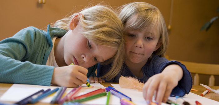 Two children drawing a picture