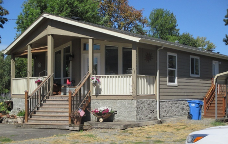 A manufactured home installed on an elevated foundation made of cinder blocks.