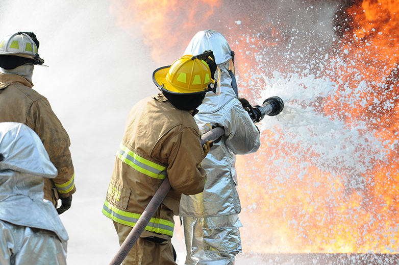 Firefighters use PFAS-containing aqueous film-forming foam (AFFF) to extinguish a blaze.