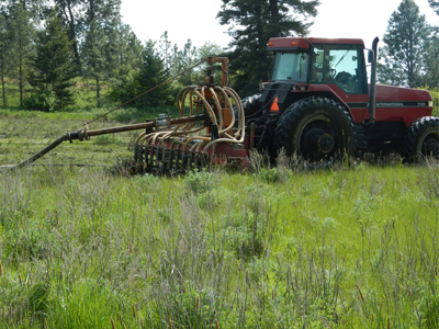 A tractor applies biosolids to a prairie in Lewis County.