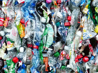 A close-up photo of flattened beverage bottles in a bale.