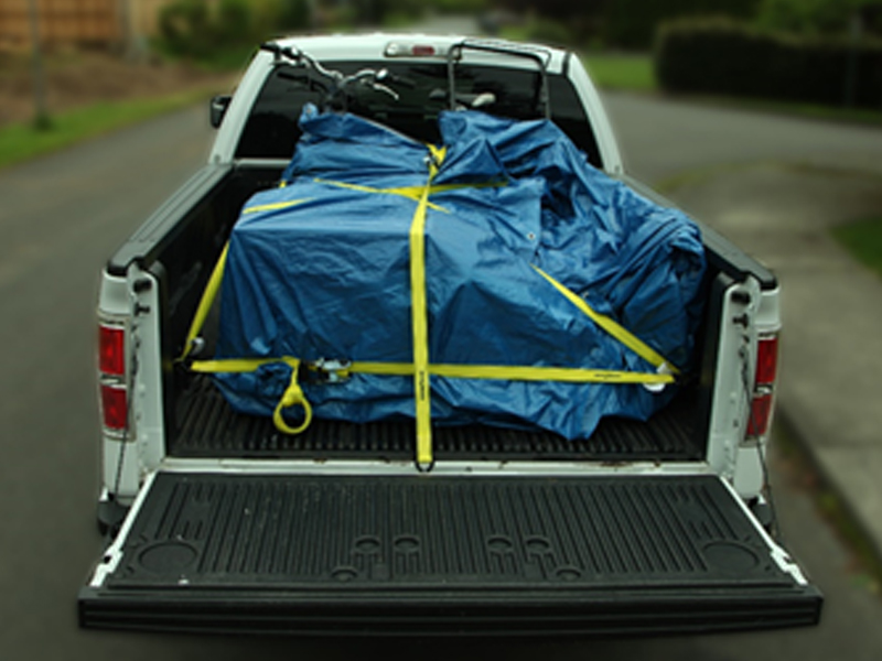 A photo of a pickup truck with a properly secured load