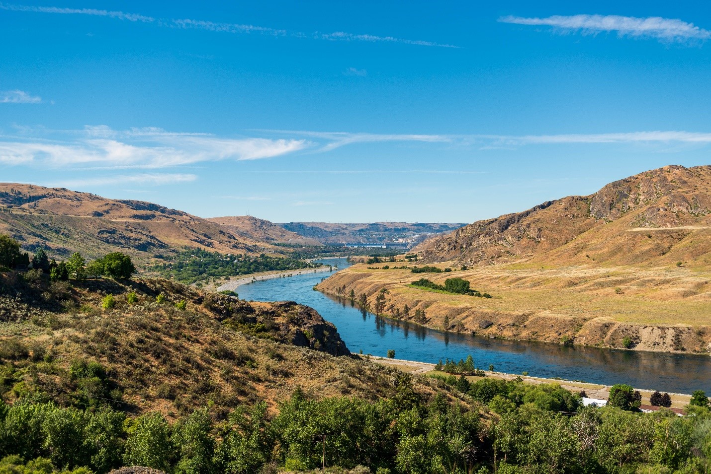 beautiful river winding through hills with dam in background