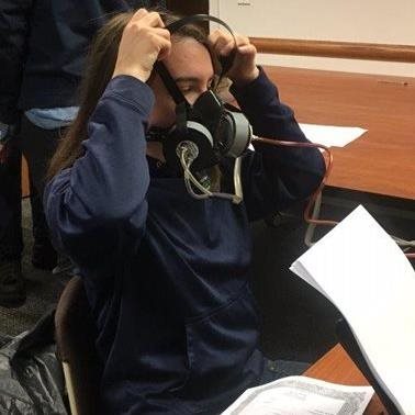 Photo of a person putting on a respirator.