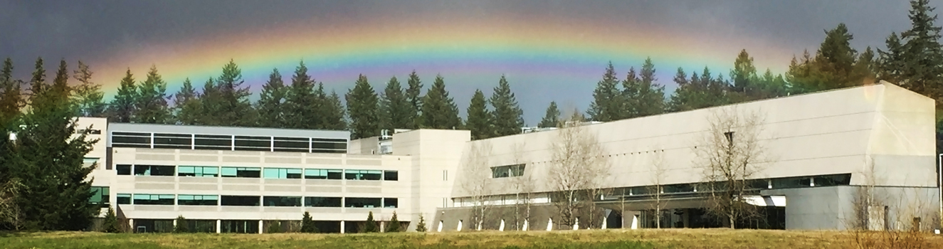 The Department of Ecology headquarters building with a rainbow over it