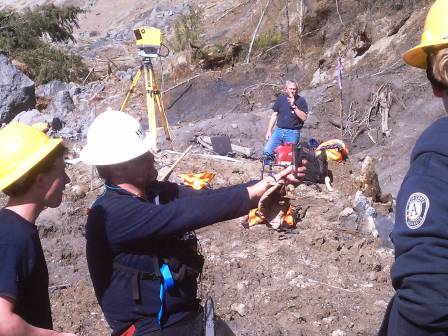 WCC AmeriCorps members survey a landscape using Lidar equipment following a landslide in Oso, Washington.