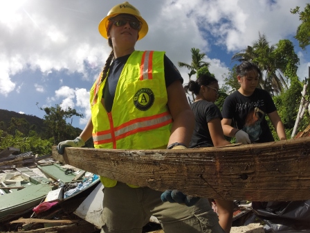 A WCC AmeriCorps member clears rubble from a collapsed building in Saipan.