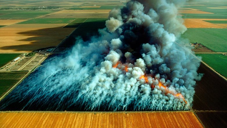Image of an agricultural burn from the air showing a lot of smoke. 