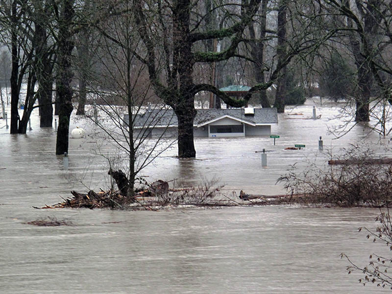 A home almost completely underwater due to flooding.