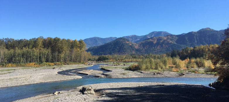 Nooksack river. Water levels are low. Rolling mountains are in the background.