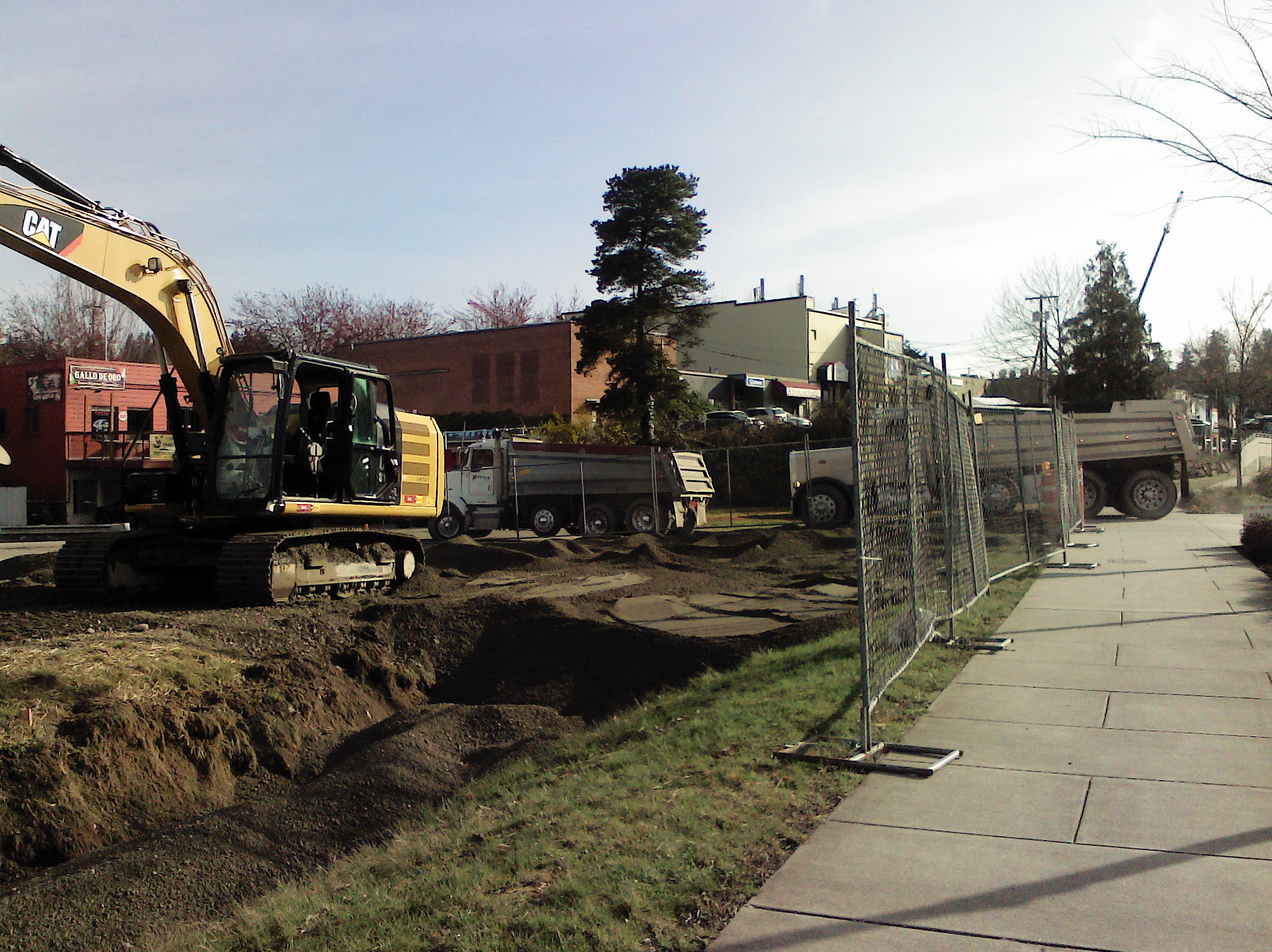 An excavator removing topsoil.