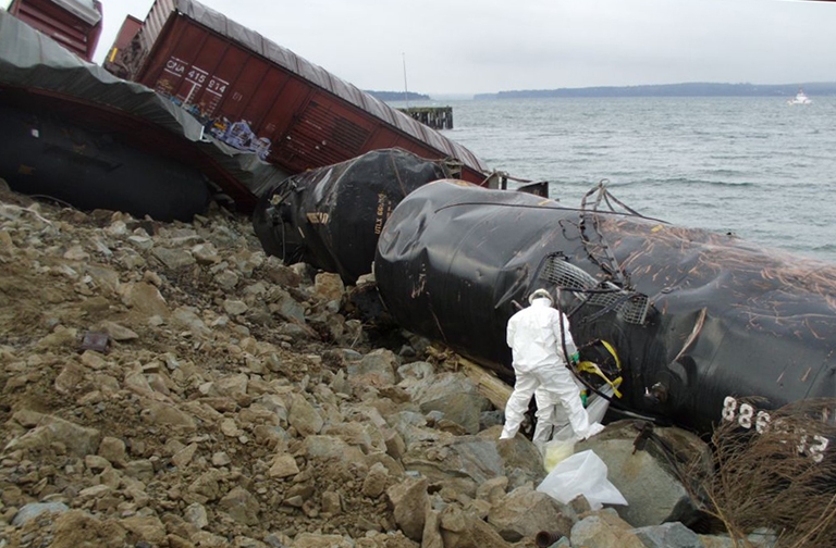 Workers securing a leaking tank car of sodium hydroxide.