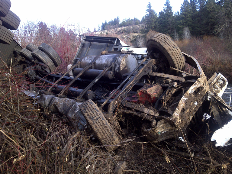 A New Legend semi truck rolled over on the river bank