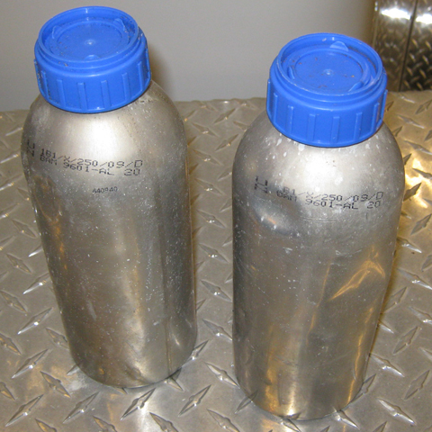 One liter aluminum canisters with blue plastic caps recovered from Sand Point and Ozette River areas.