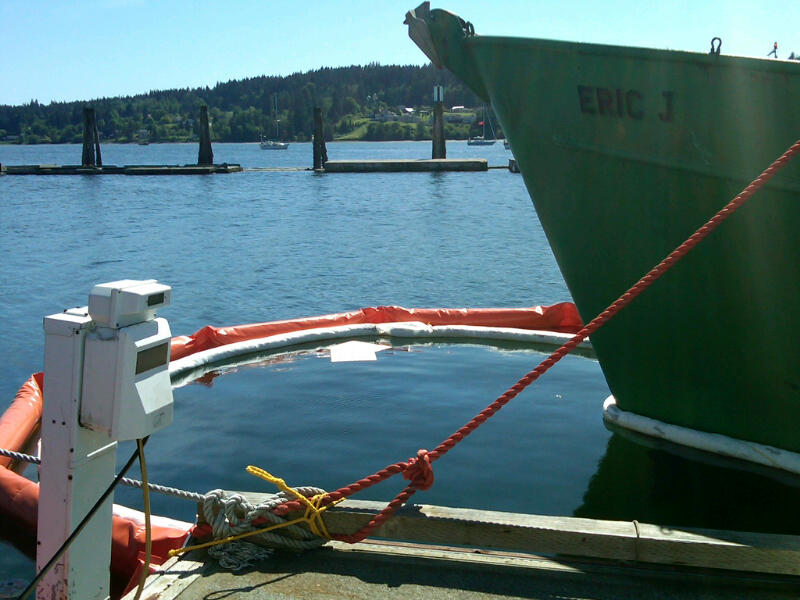 The Eric J surrounded by booms and other oil cleanup materials.