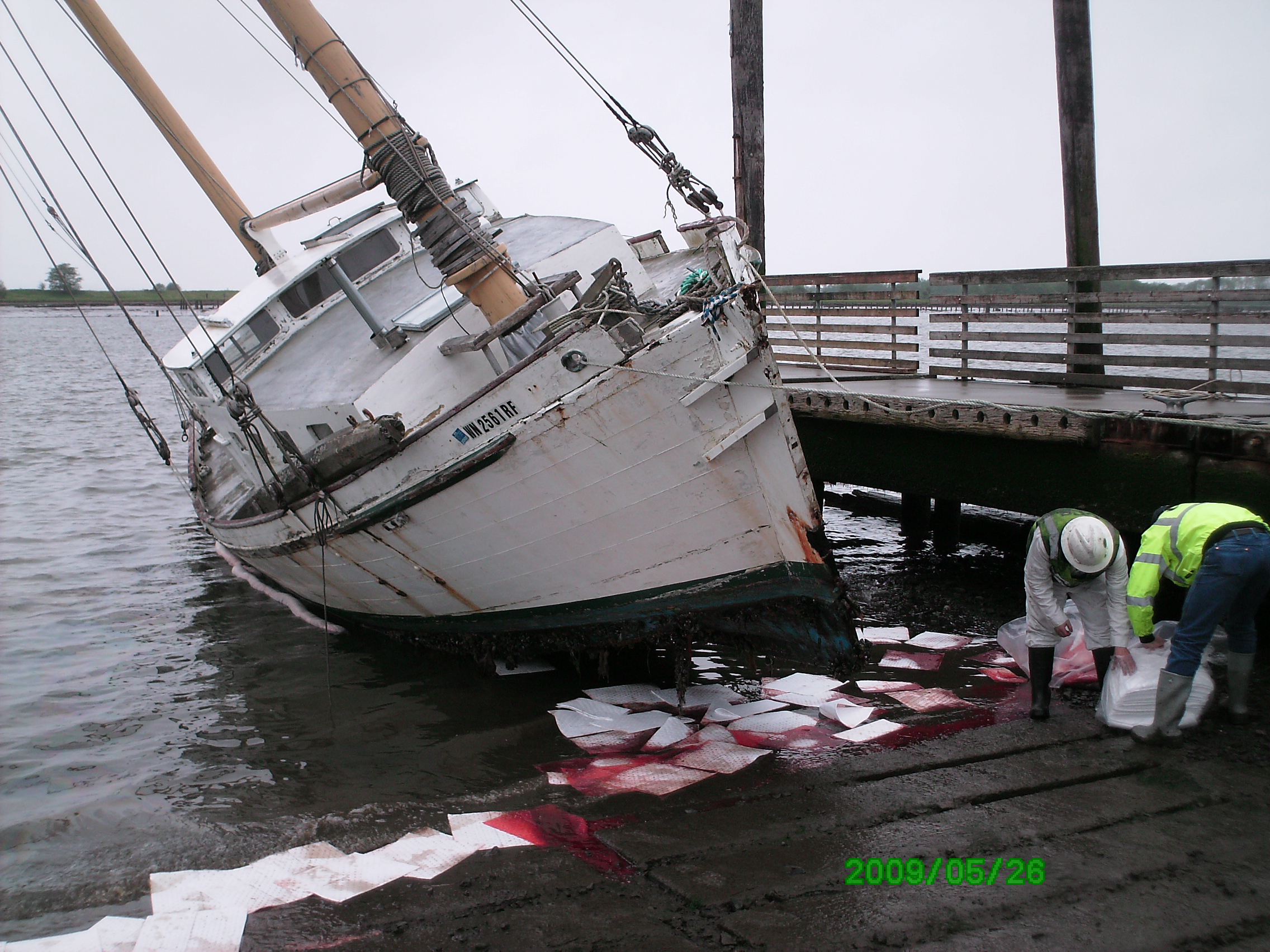 The vessel resting on its starboard side during low tide.