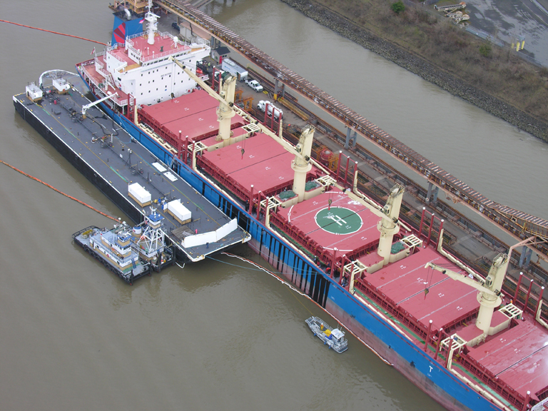 Aerial view of vessel and barge.
