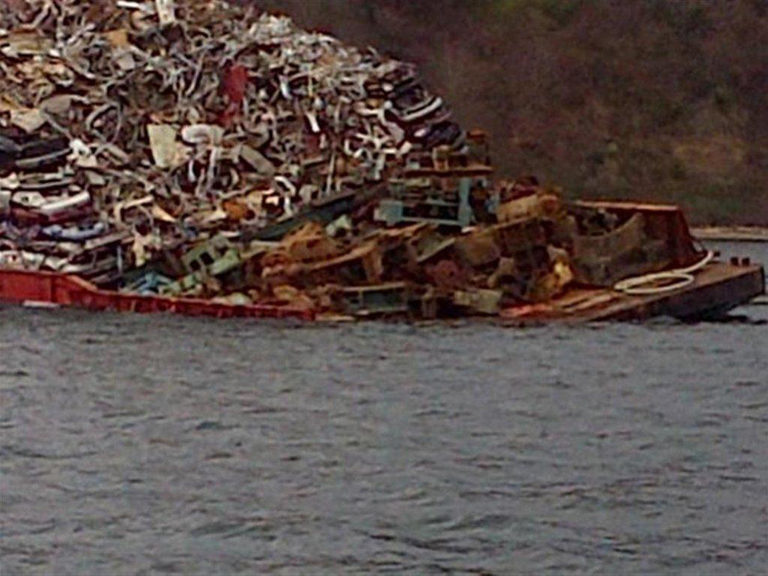 An Amix Marine Services barge listing in Commencement Bay.