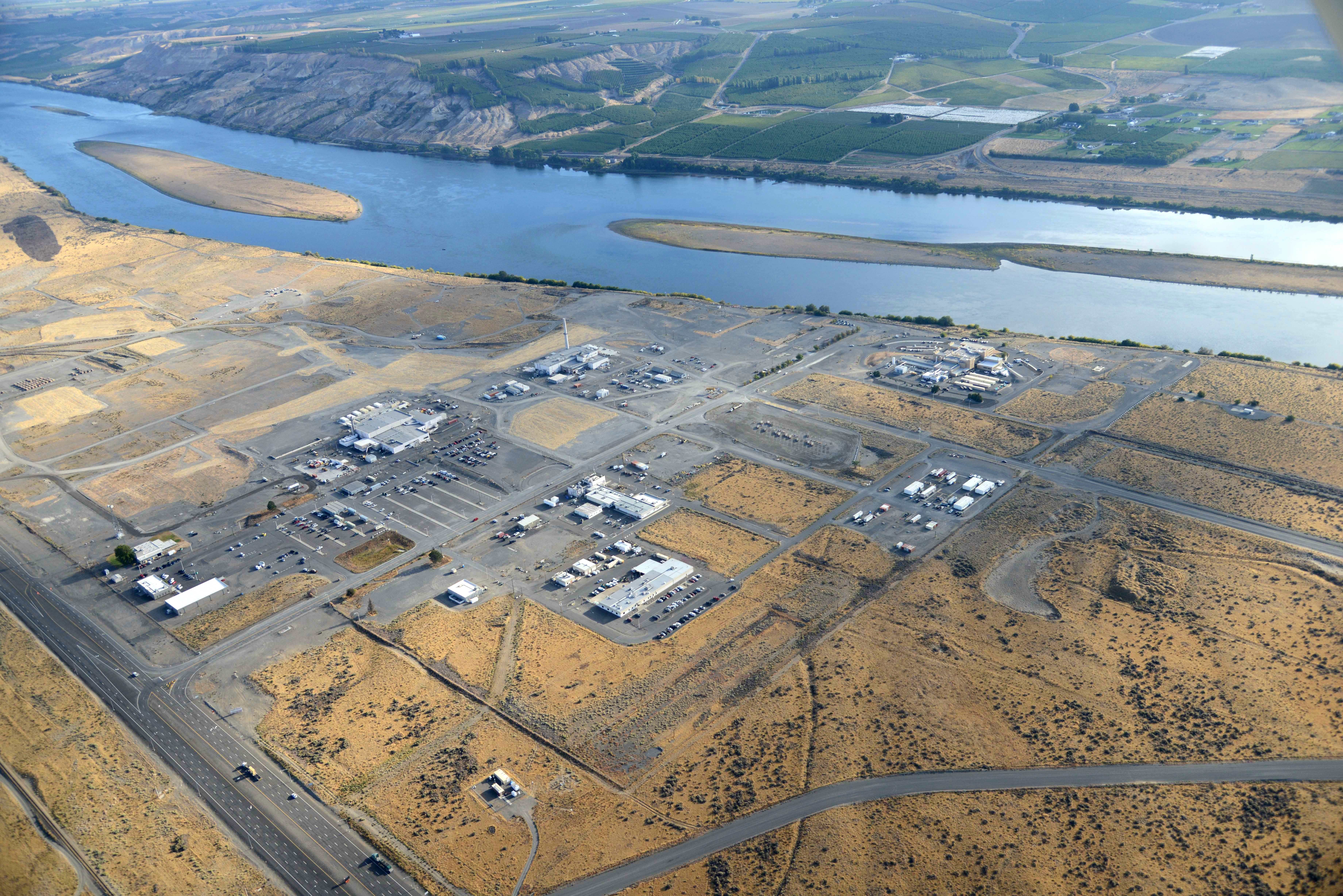 Aerial view of Hanford's 300 Area, showing a variety of buildings spread out over a large swath of land near the Columbia River