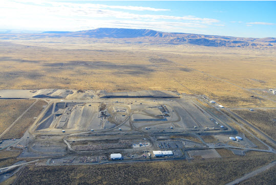 Aerial view of Environmental Restoration Disposal Facility, a massive landfill with various trucks, offices and equipment around it.