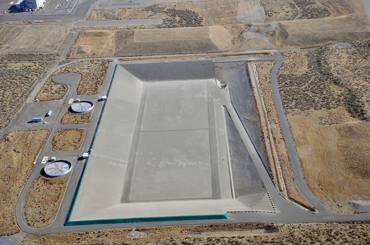 Aerial view of Integrated Disposal Facility, a large, unfilled landfill.