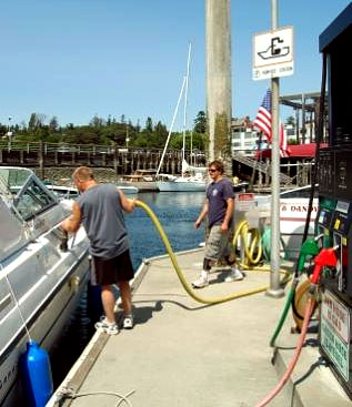A man using a pumpout station to remove sewage from his boat.