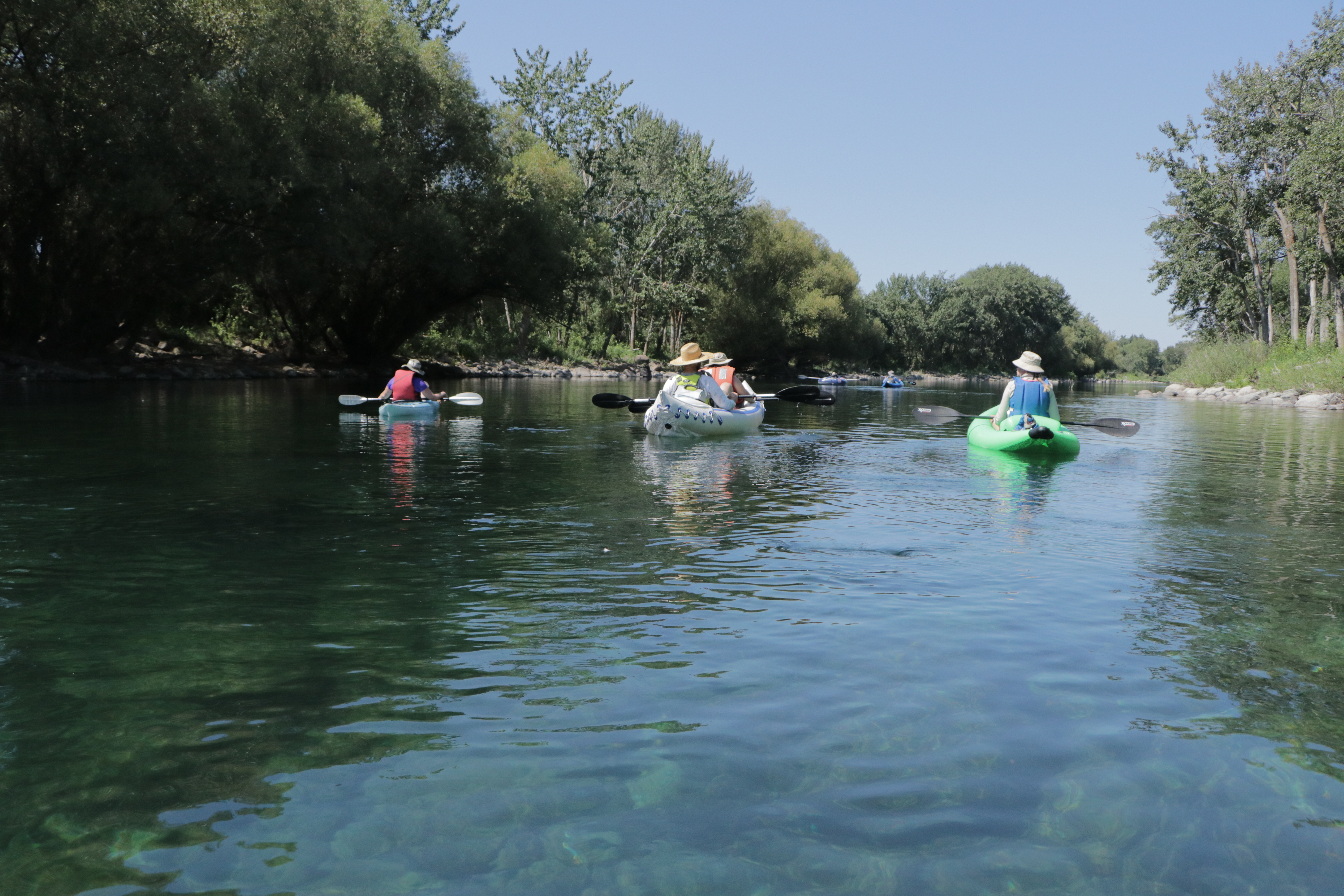 people in kayak going down river