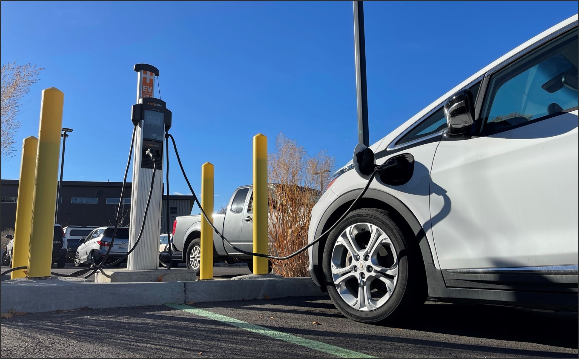 An electric vehicle charging in an Eastern Washington parking lot.