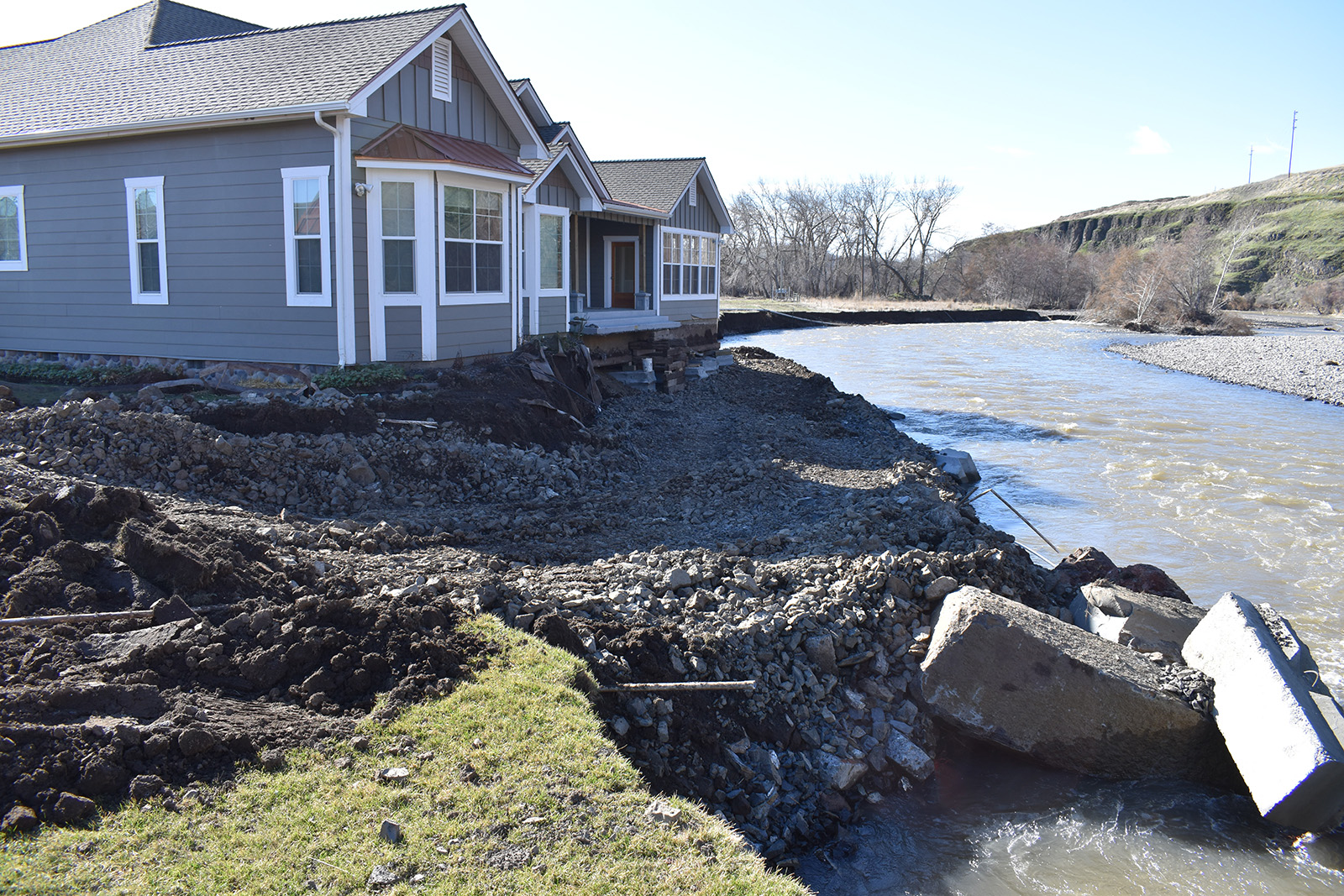 house along shoreline with severe erosion.