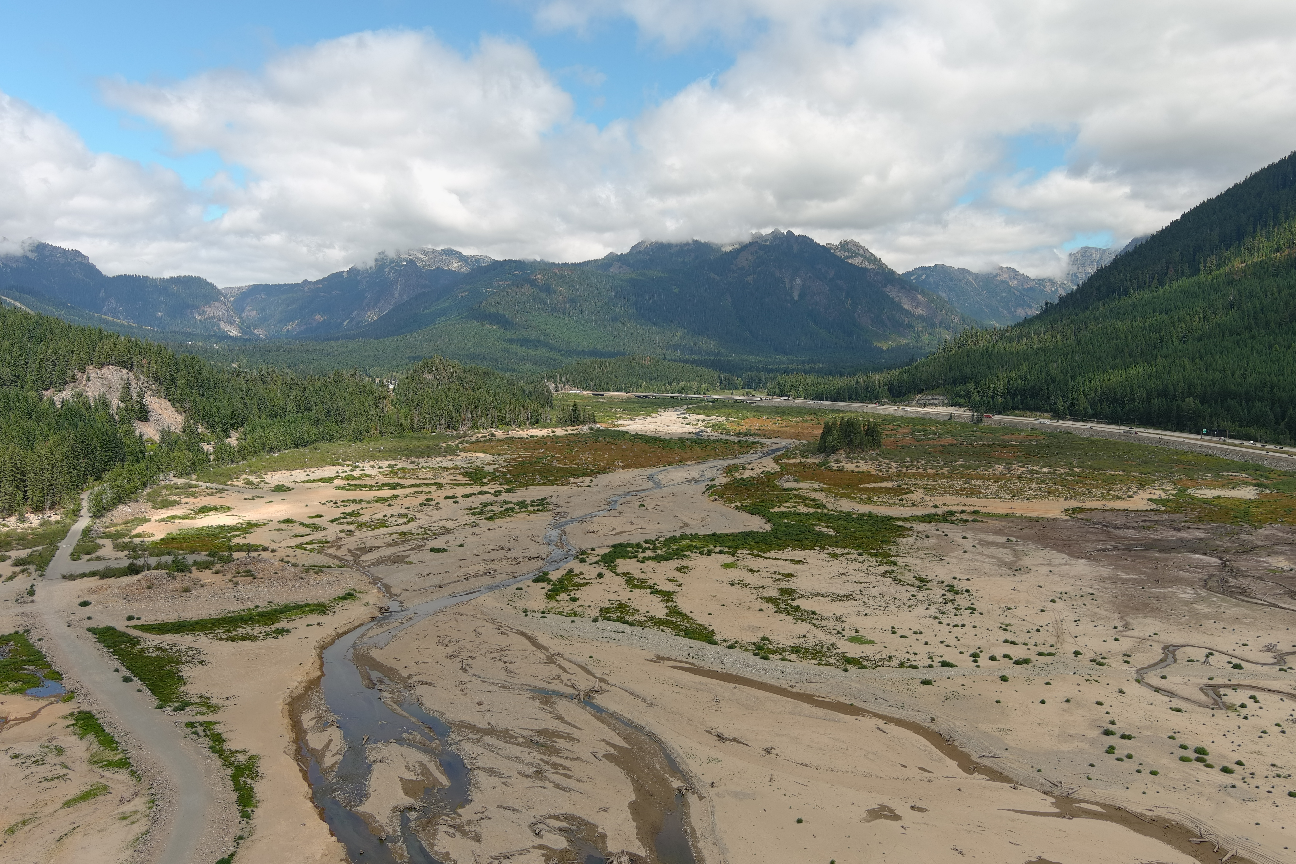 Dry river with green hills in the background