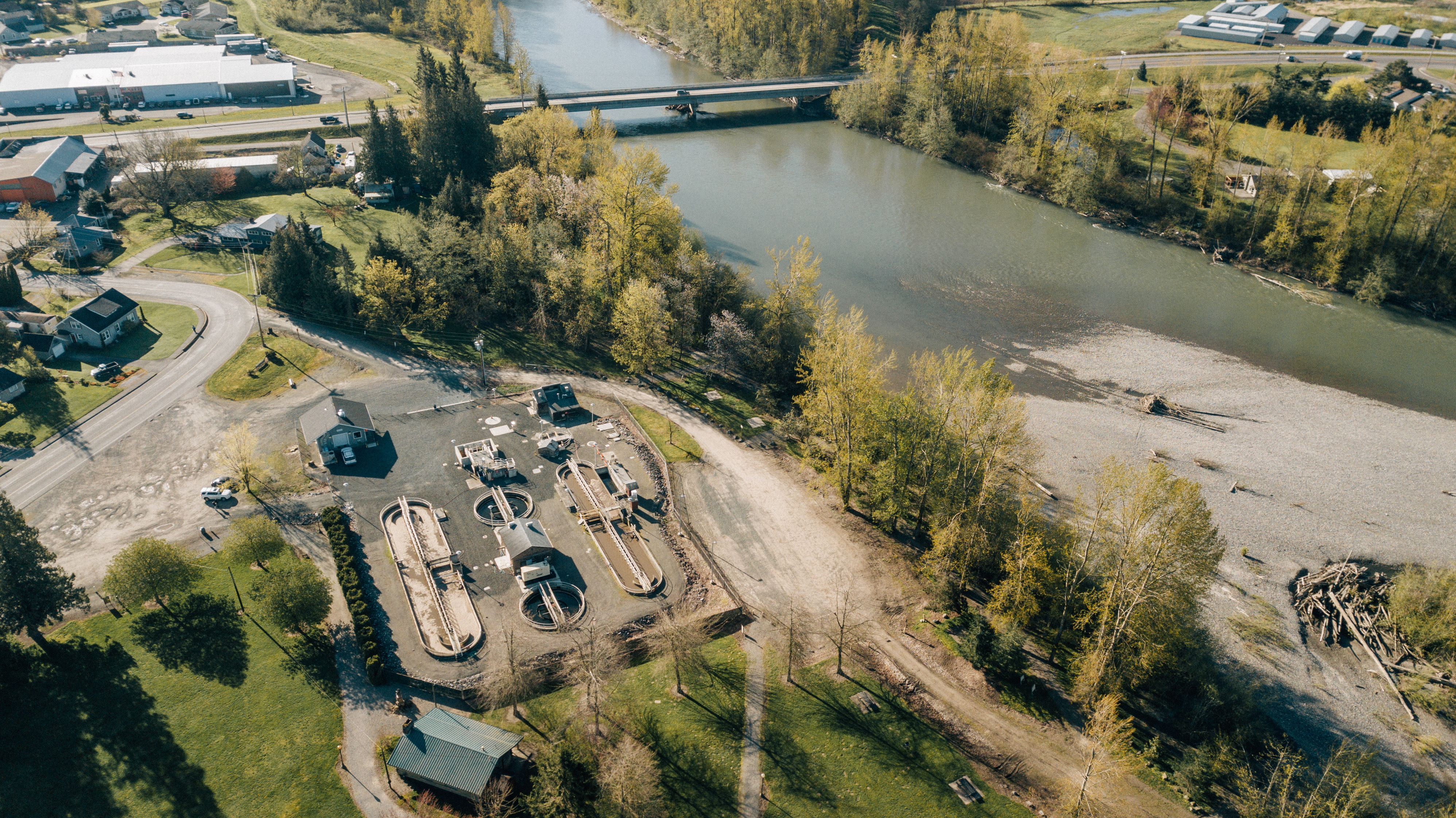Aerial of wastewater treatment plant next to a body of water