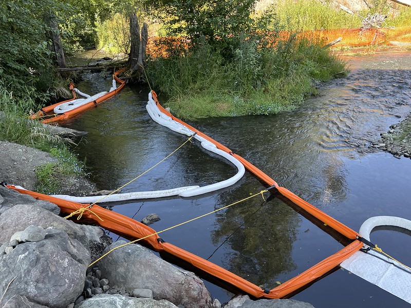 Containment boom and sorbent materials deployed in Indian Creek near where it meets the Elwha River.