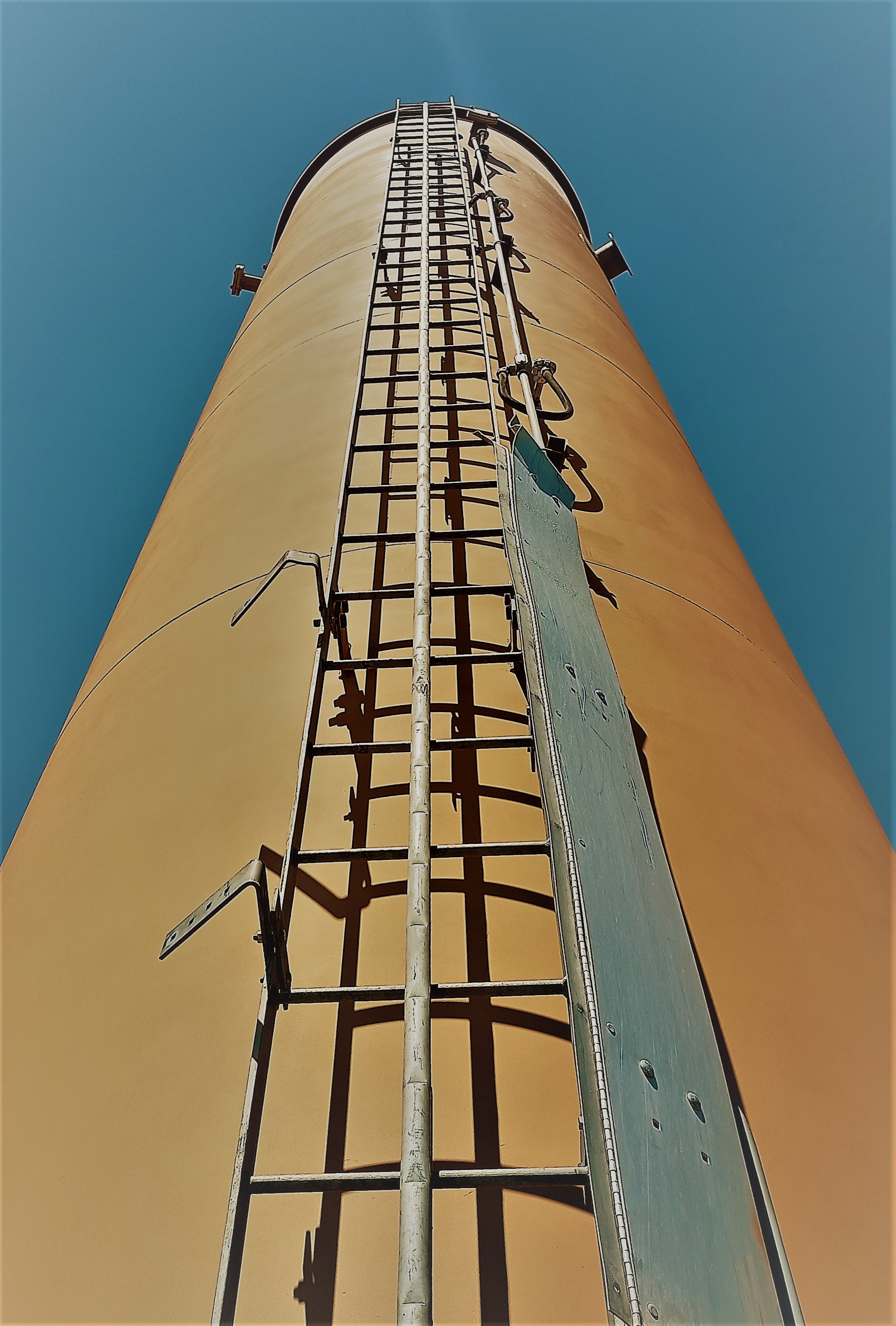 An enclosed flare tower reaching toward the sky.