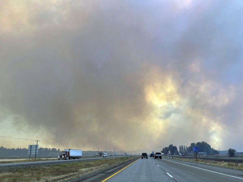 Wildfire smoke can be seen from a highway in Spokane