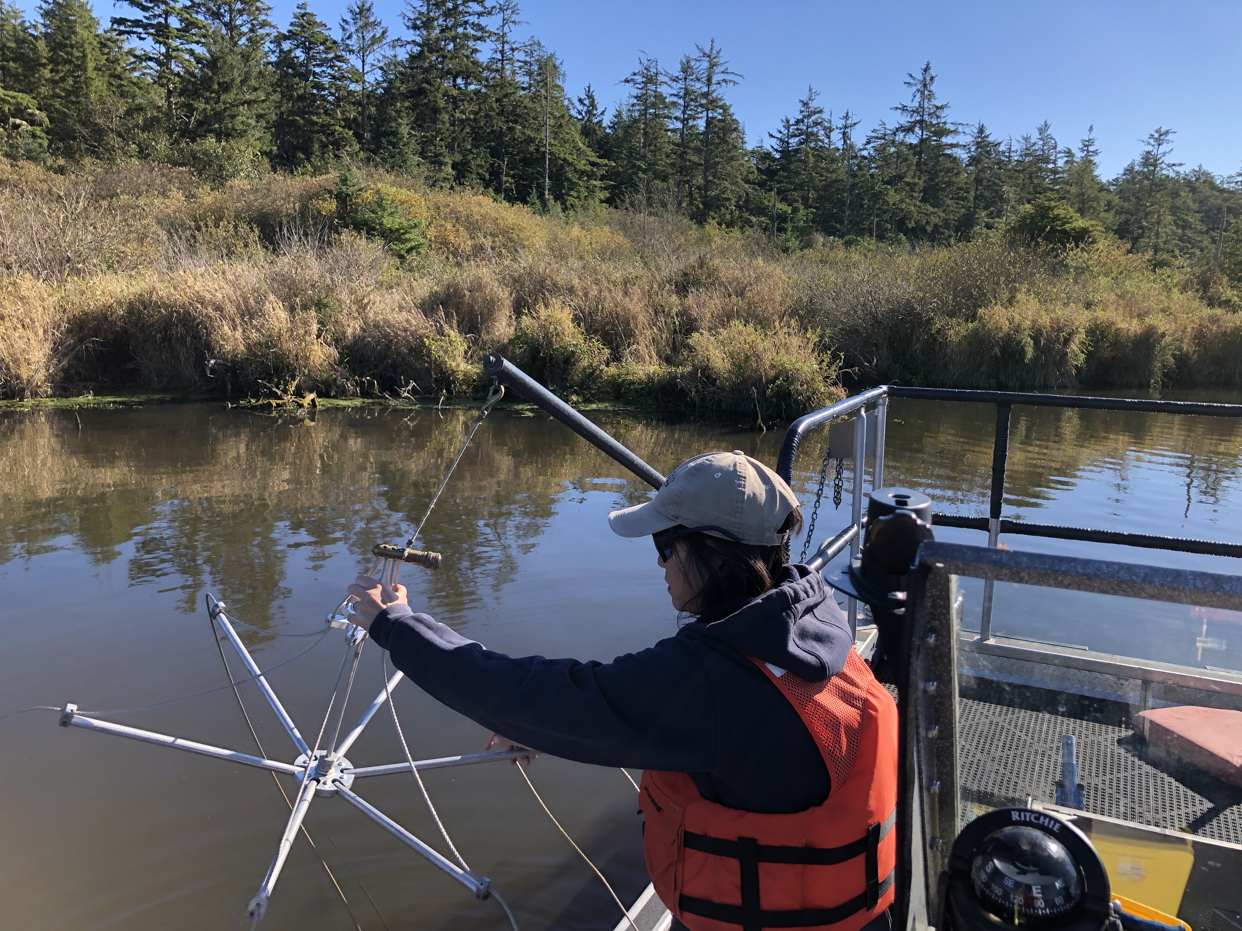 A scientist sets up the anode boom on an electrofishing boat.