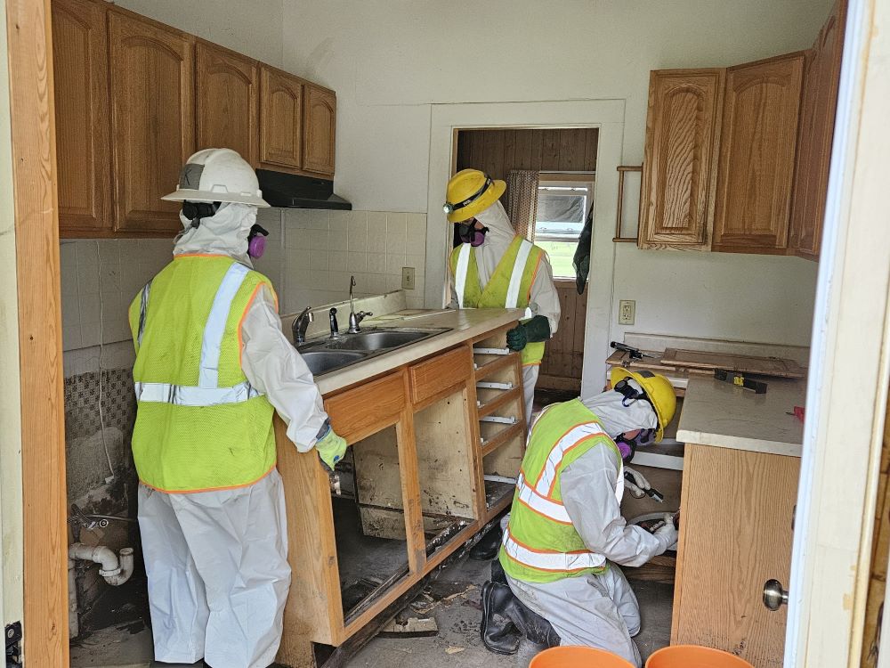 WCC members remove cabinetry from a household kitchen.
