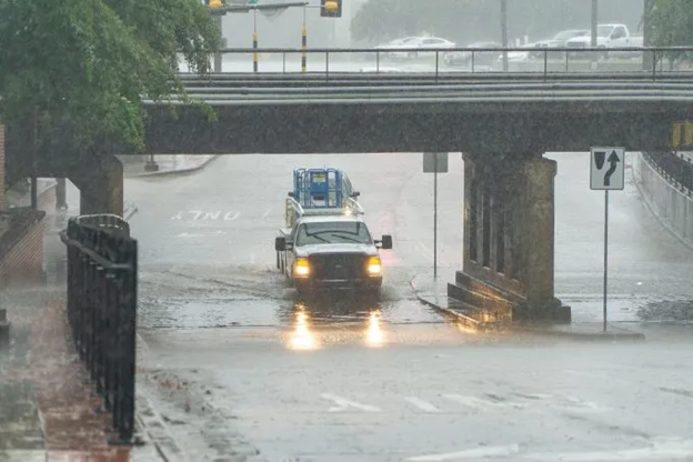 A truck driving through flooded streets