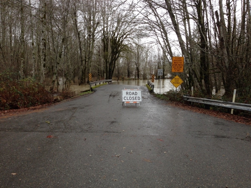 A "road closed" sign in gray and rainy weather