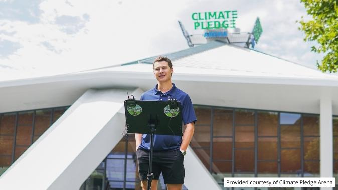 Professional hockey player Yanni Gourde talks to media about the We Keep WA Litter Free campaign outside the Climate Pledge Arena.