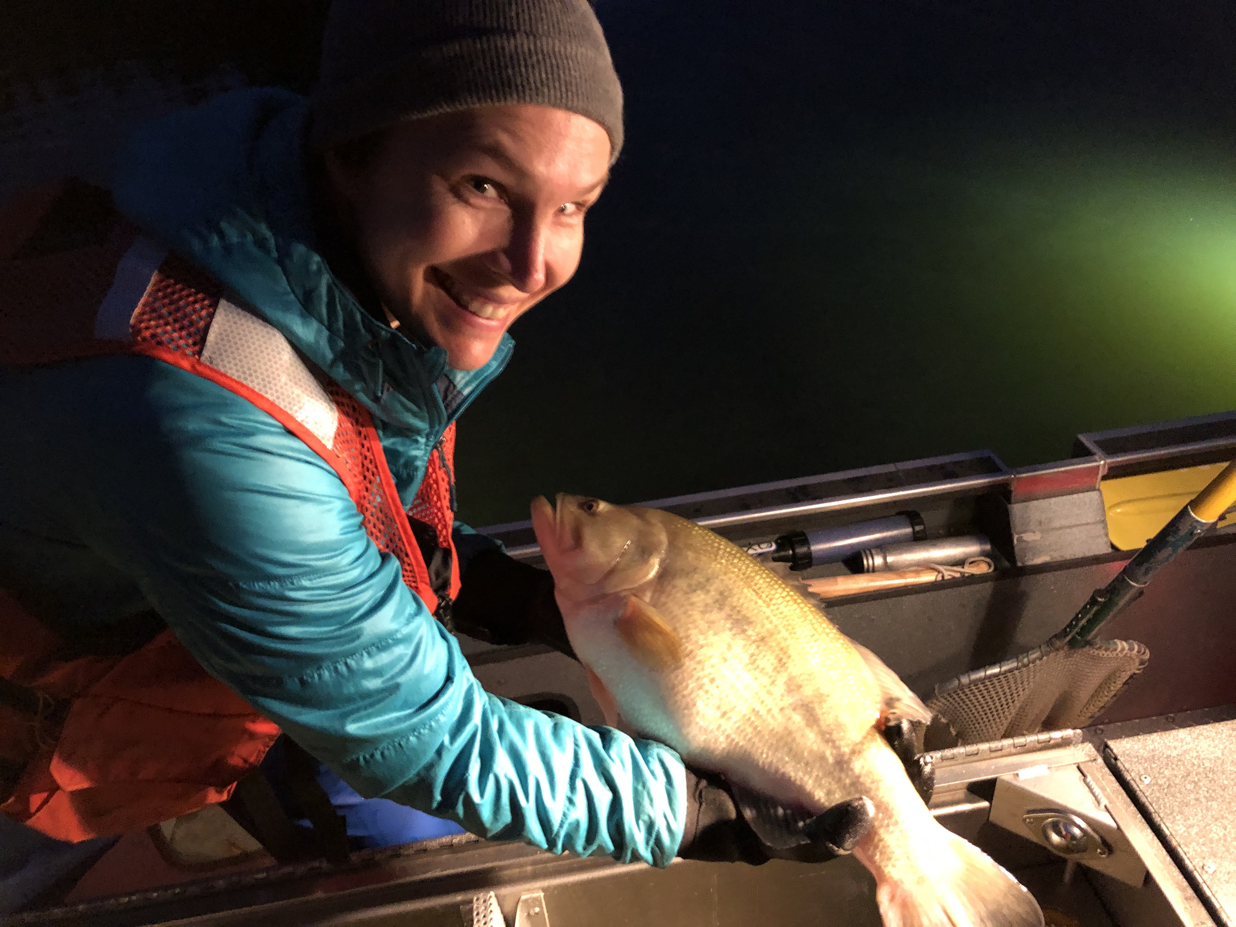 Scientist holds a big largemouth bass.