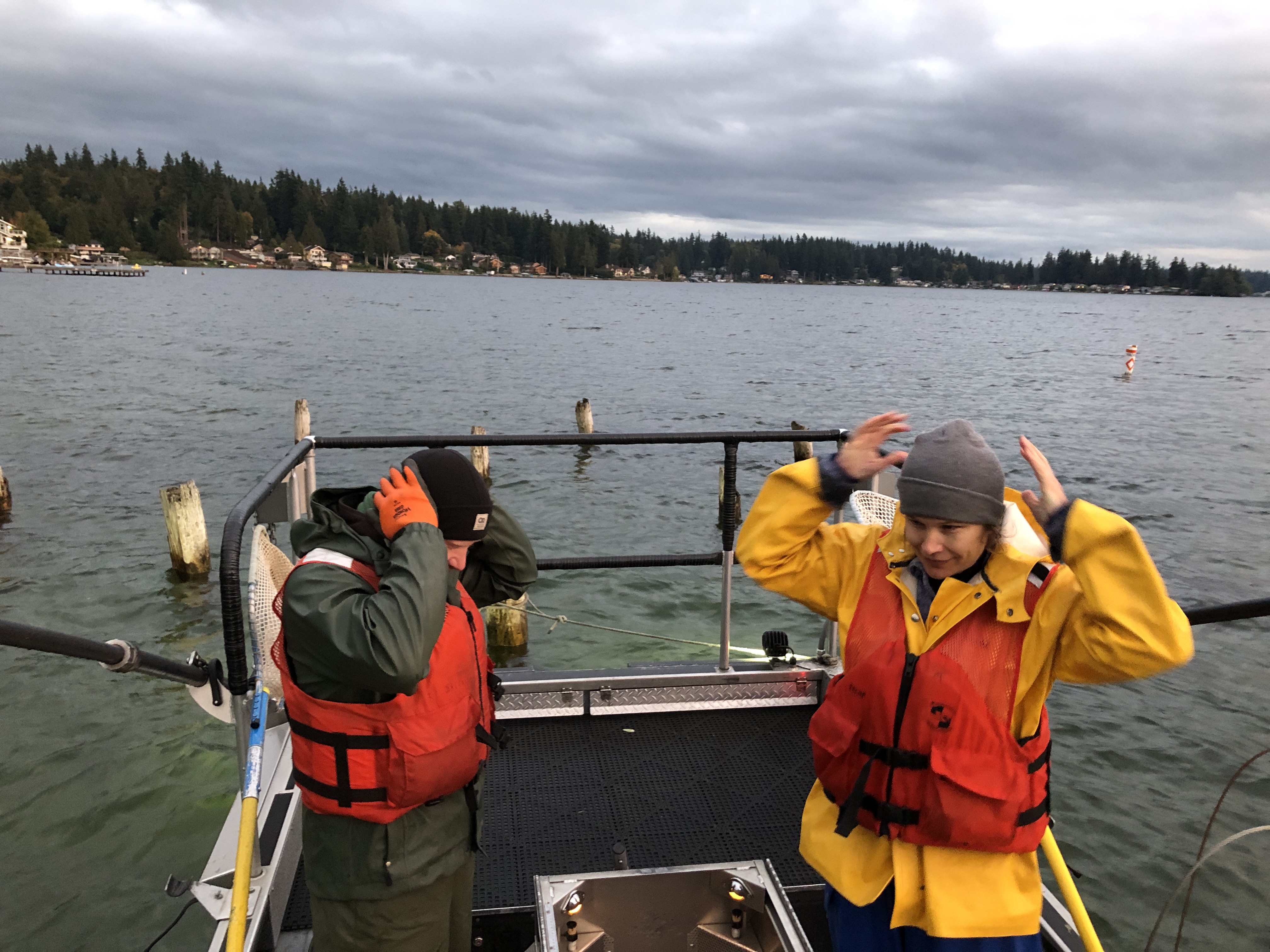 Two scientists check their gear before fishing.