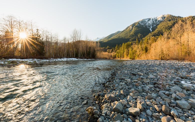 Snoqualmie River with forested mountains in the background.