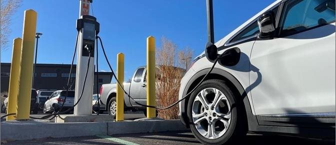 Electric car plugged in at a charging station.