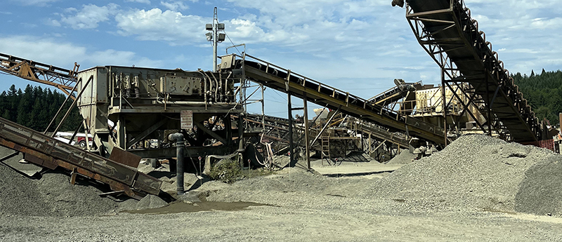 Machines and a large pile of gravel.